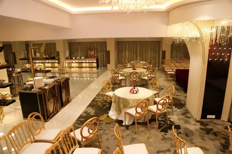 Golden Leaf Banquet's flagship hall — round tables under crystal chandeliers, gold-and-white décor.