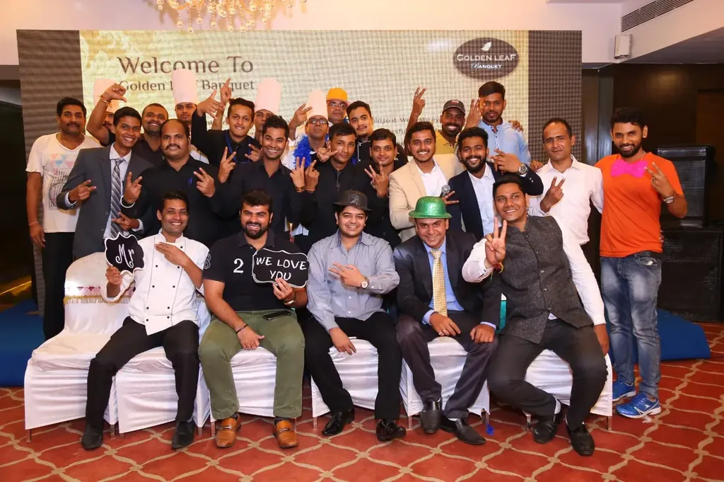 The Golden Leaf Banquet team — service staff, chefs, and managers gathered beneath the venue's welcome backdrop.