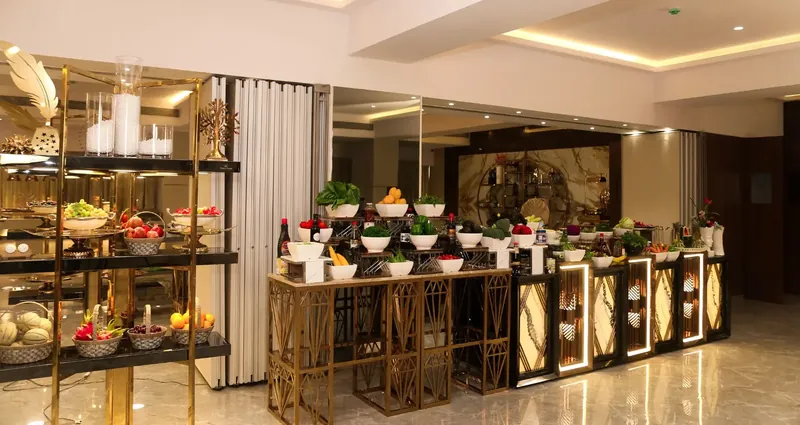 Gold drapes and floral garlands framing the Golden Leaf Banquet stage